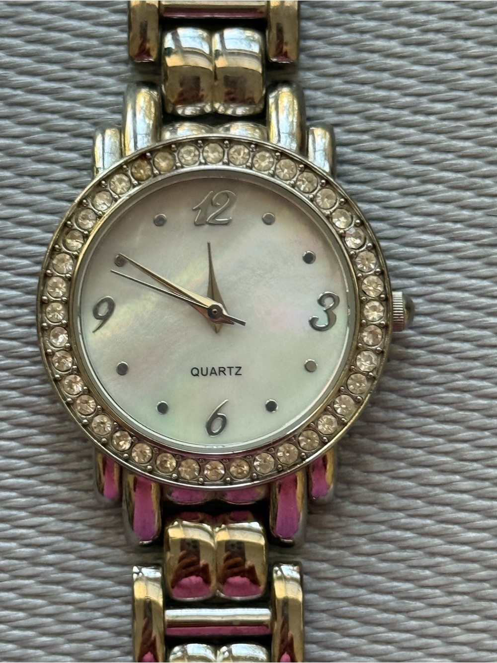 Silver tone watch with round pearl face crystals